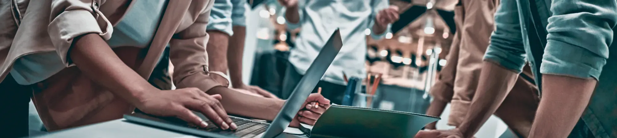 people working over a desk 